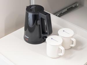 Příslušenství pro přípravu čaje a kávy v ubytování Hotel Wavellent Yangyang
