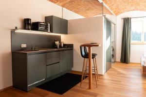 a kitchen with a counter and a bar in a room at Himetsbergerhof in Aurolzmünster