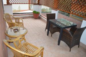 a patio with chairs and a table and a table and chairs at Villa Alba Boutique Hotel in Pescara