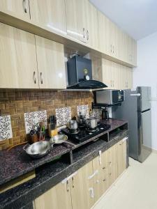 a kitchen with a counter top with pots and pans at Peaceful 2 Bedroom Flat near Airport in Hyderabad
