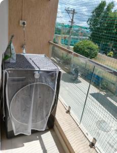 a container sitting on a balcony next to a window at Peaceful 2 Bedroom Flat near Airport in Hyderabad +53 photos