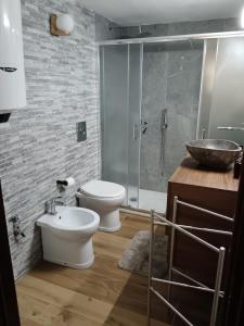 a bathroom with a toilet and a sink and a shower at Bilocale Centro Valtournenche in Valtournenche +18 photos