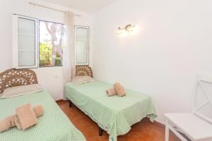 a room with two beds and a window at Apartamento con estupenda terraza-a4 in Son Xoriguer