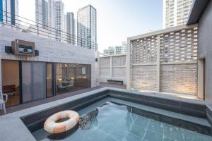 a swimming pool in the middle of a building at H-Avenue Hotel Haeundae in Busan