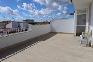 a balcony with two chairs and a view of the city at Hospedium GL Andújar Boutique in Andújar