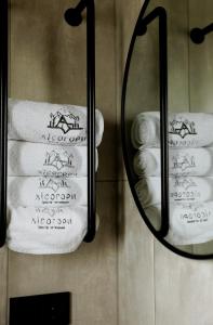 a mirror in a bathroom with towels on a wall at Лісогори in Slavske