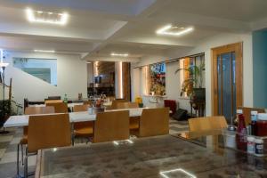 a restaurant with tables and chairs in a room at Abbey Point Hotel in London
