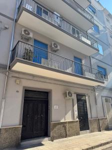 an apartment building with a door and a balcony at Salento Apartment in Brindisi