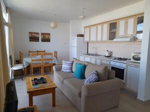 a living room with a couch and a table at Crystal Bay Marina B3-5 in Troulli