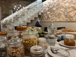 a table with jars of food on a counter with stairs at Pietrasanta Ai Teatri in Pietrasanta