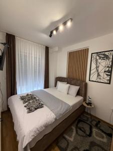 Postel nebo postele na pokoji v ubytování Royal apartmani Vrnjačka Banja