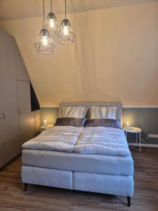 a bedroom with a large bed with two lights at Apartment "Diana" in historischer Villa an der Emser Therme in Bad Ems