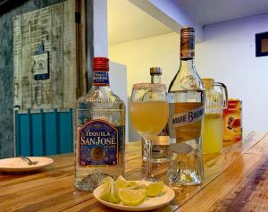 a bottle of whiskey and glasses on a wooden table at Panoramic Paradise 2 in Marianne Island