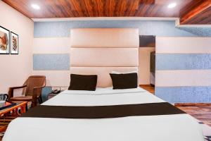 Ένα ή περισσότερα κρεβάτια σε δωμάτιο στο Super Hotel O Palava Dombivali