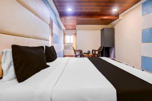 Ένα ή περισσότερα κρεβάτια σε δωμάτιο στο Super Hotel O Palava Dombivali