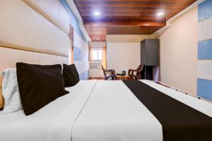 Ένα ή περισσότερα κρεβάτια σε δωμάτιο στο Super Hotel O Palava Dombivali