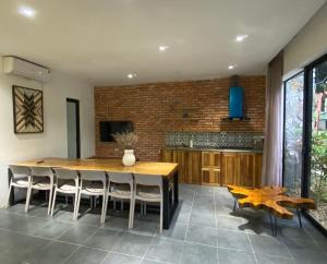 a dining room with a wooden table and chairs at Large Mango Villa in Ba Vì