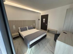 Voodi või voodid majutusasutuse Hotel Cocceio toas