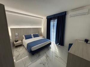 Voodi või voodid majutusasutuse Hotel Cocceio toas