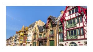 a group of tall buildings in a city at Le petit cocon au bord de mer in Mers-les-Bains
