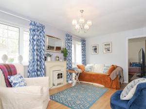 a living room with a bed and a fireplace at No 1 The Heathers in Saint Cleer