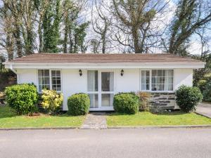 a white house with bushes in front of it at No 1 The Heathers in Saint Cleer +12 photos