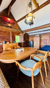 a dining room with a wooden table and chairs at Fisherman Shack in Nusa Lembongan