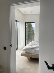 a bedroom with a bed and a large window at Лісогори in Slavske