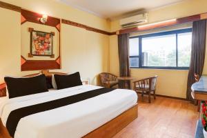 En eller flere senge i et værelse på Super Townhouse Subhash Nagar Formerly Royal Palazzo + 24 billeder