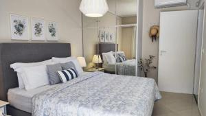 a bedroom with a large bed and a mirror at Overlooking the blue sea in Rafina