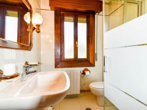 a bathroom with a sink and a toilet at Encantadora casa familiar in Liérganes +23 photos