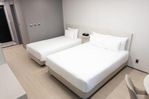 Postel nebo postele na pokoji v ubytování Hotel Wavellent Yangyang