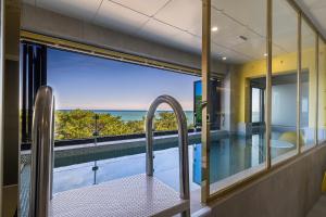 a house with a view of a swimming pool and the ocean at From H Brown Dot Hotel Gyeongju Yangnam in Gyeongju