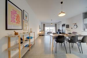 a kitchen and dining room with a table and chairs at Modern Marsaxlokk Apartment in Marsaxlokk