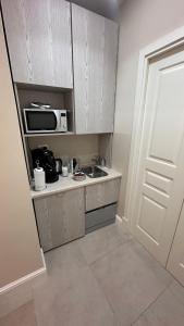 a small kitchen with a sink and a microwave at La Finestra Sul Vulcano in Roccamonfina +30 photos