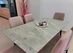 a dog is sitting in a bowl on a table at New Akina Kajang2 Homestay 12pax in Semenyih