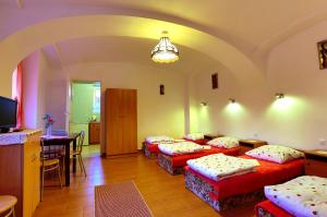 a room with four beds in it with a table and chairs at Ranczo u Jana in Stronie Śląskie