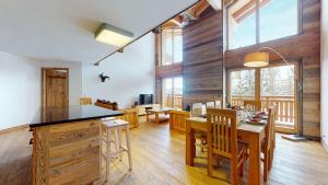 a kitchen and dining room with a table and chairs at Les Mayens MA 021 - LUXURY apartment 18 pers in Veysonnaz
