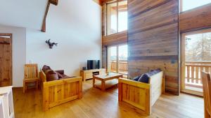 a living room with wooden walls and wooden floors at Les Mayens MA 021 - LUXURY apartment 18 pers in Veysonnaz