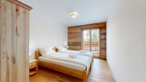 a bedroom with a bed and a window at Les Mayens MA 021 - LUXURY apartment 18 pers in Veysonnaz