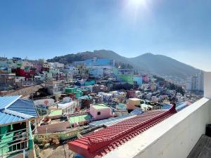 a view of a city with buildings and mountains at Aloha Green Gamcheon in Busan