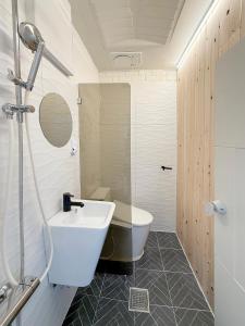 a bathroom with a white sink and a shower at Aloha Green Gamcheon in Busan +14 photos