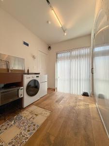 a kitchen with a washer and dryer in a room at Aloha Green Gamcheon in Busan