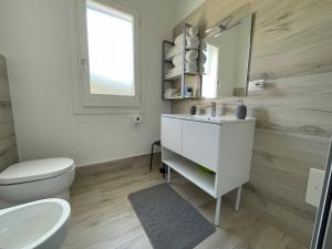 a bathroom with a sink and a toilet and a mirror at La Dolce Vita in Campofelice di Roccella +23 photos