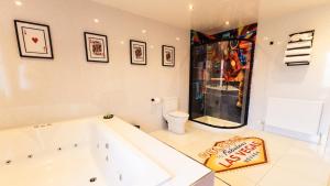 a large bath tub in a room with a toilet at St Hildas Complex in Hinderwell