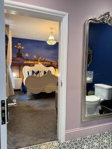 a bedroom with a bed and a mirror at St Hildas Complex in Hinderwell