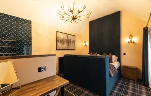 a room with a bed and a black cabinet at St Hildas Complex in Hinderwell