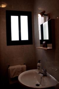 a bathroom with a sink and a window at El Aceitón in Cortegana