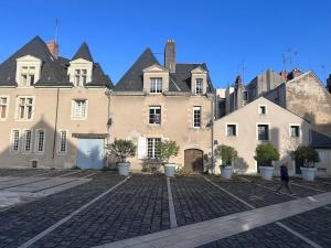 a man walking in front of a large building at Studio CENTRE VILLE ANGERS 1ER ETAGE - 2 PERSONNES in Angers
