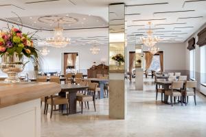 a dining room with tables and chairs and chandeliers at Der Kronprinz in Fuhrbach